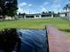 A view from the water showcases the property's expansive lawn and screened lanai at 1216 W Lake Buckeye Dr, Winter Haven, FL 33881