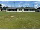 Expansive backyard featuring a full lawn and a screened-in lanai spanning the home's rear at 1216 W Lake Buckeye Dr, Winter Haven, FL 33881