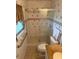 Tight full bathroom with glass shower, ceramic tile, and toilet in neutral color palette at 1216 W Lake Buckeye Dr, Winter Haven, FL 33881