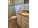 Bathroom featuring glass enclosed shower, toilet and vanity with granite top and chrome hardware at 1216 W Lake Buckeye Dr, Winter Haven, FL 33881