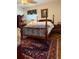 Classic bedroom with a four-poster bed, a rug with a pattern design, and wooden furniture at 1216 W Lake Buckeye Dr, Winter Haven, FL 33881
