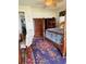 Classic bedroom with a four-poster bed, a rug with a pattern design, and wooden furniture at 1216 W Lake Buckeye Dr, Winter Haven, FL 33881