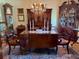 Traditional dining room with antique hutch, table with candles, and grandfather clock at 1216 W Lake Buckeye Dr, Winter Haven, FL 33881