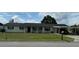 Charming one-story home featuring a well-maintained front yard and convenient carport at 1216 W Lake Buckeye Dr, Winter Haven, FL 33881