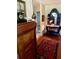 Welcoming hallway features detailed wood furniture and a patterned red rug on brick floors at 1216 W Lake Buckeye Dr, Winter Haven, FL 33881