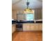 Traditional kitchen featuring white cabinets, black countertops, stainless steel appliances, and a charming decorative light fixture at 1216 W Lake Buckeye Dr, Winter Haven, FL 33881