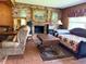 Charming living room features a brick fireplace and comfortable seating area at 1216 W Lake Buckeye Dr, Winter Haven, FL 33881