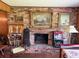 Living room features a cozy brick fireplace and decorative art above at 1216 W Lake Buckeye Dr, Winter Haven, FL 33881
