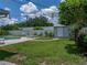 A spacious, fenced backyard has a pool, a shed that matches the home, and shaded seating areas for relaxing outdoors at 1232 Fairlee St, Lakeland, FL 33813
