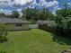 A well-maintained lawn in the backyard is framed by privacy fences and mature trees at 1232 Fairlee St, Lakeland, FL 33813