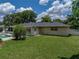 Expansive backyard with a pool, lush lawn, and peaceful outdoor living space at 1232 Fairlee St, Lakeland, FL 33813