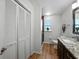 Bathroom with double door closet, neutral colors and decorative mirror at 1232 Fairlee St, Lakeland, FL 33813