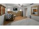 This bedroom includes tile flooring, a ceiling fan, closet, dressers and a comfortable armchair at 1232 Fairlee St, Lakeland, FL 33813