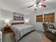 Comfortable bedroom featuring a ceiling fan and natural light from the windows with woven shades at 1232 Fairlee St, Lakeland, FL 33813