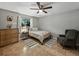 Cozy bedroom with ample natural light, ceiling fan, decorative rug, and tile floor at 1232 Fairlee St, Lakeland, FL 33813