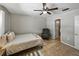 Relaxing bedroom with tile flooring, ceiling fan, closet, and exterior views at 1232 Fairlee St, Lakeland, FL 33813