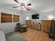 The bedroom has a ceiling fan, TV, and dressers for ample storage and comfort at 1232 Fairlee St, Lakeland, FL 33813