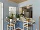 Cozy breakfast bar area with granite countertops, views into the kitchen, and bright natural light at 1232 Fairlee St, Lakeland, FL 33813