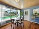 Dining area with views of the pool, wood floors, blue walls, and a beadboard ceiling at 1232 Fairlee St, Lakeland, FL 33813