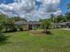 Charming single-story home featuring a well-manicured lawn and beautiful landscaping at 1232 Fairlee St, Lakeland, FL 33813
