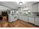 Bright kitchen with white cabinets, stainless appliances, and wood flooring at 1232 Fairlee St, Lakeland, FL 33813