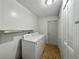 Efficient laundry room featuring a washer, dryer, shelves, and storage space at 1232 Fairlee St, Lakeland, FL 33813
