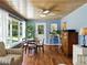Bright living room featuring a dining table, light blue walls, ceiling fan, and outdoor pool views at 1232 Fairlee St, Lakeland, FL 33813