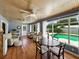 Spacious living room with wood floors, blue walls, a beadboard ceiling, and a pool view at 1232 Fairlee St, Lakeland, FL 33813