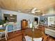 Open-concept living room featuring wood floors, blue walls, a beadboard ceiling, and a breakfast bar at 1232 Fairlee St, Lakeland, FL 33813