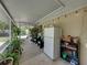 Enclosed patio with seating, plants, a refrigerator, and string lights for ambiance, perfect for outdoor living at 1232 Fairlee St, Lakeland, FL 33813