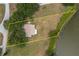 Aerial view showcases the home's expansive lot, bordering water with a dock at 21 Lake Ave, Winter Haven, FL 33880