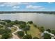 Aerial view of a lakefront property showcasing trees, large lot, and expansive water views at 21 Lake Ave, Winter Haven, FL 33880