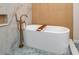 Bright bathroom featuring a modern tub, and stylish blue mosaic tile flooring at 21 Lake Ave, Winter Haven, FL 33880
