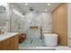 Bright bathroom featuring a modern tub, glass shower, and stylish blue mosaic tile flooring at 21 Lake Ave, Winter Haven, FL 33880