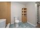 Modern bathroom featuring blue-tiled floors, a floating vanity, and a luxurious soaking tub with unique wood wall at 21 Lake Ave, Winter Haven, FL 33880