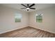 This bedroom features two windows and light wood grain flooring at 21 Lake Ave, Winter Haven, FL 33880