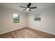 Bedroom with modern ceiling fan and windows for ample natural light at 21 Lake Ave, Winter Haven, FL 33880