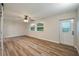 Bedroom featuring luxury vinyl plank flooring, a ceiling fan, natural light, and an access door to the backyard at 21 Lake Ave, Winter Haven, FL 33880