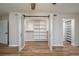 Walk-in closet with open shelving and double barn doors leading into the large main bedroom suite at 21 Lake Ave, Winter Haven, FL 33880
