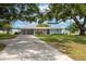 Charming home exterior featuring a covered carport, a vibrant blue front door and a lake view at 21 Lake Ave, Winter Haven, FL 33880