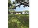 Charming single-story home featuring a lush lawn, mature trees, and a convenient carport at 21 Lake Ave, Winter Haven, FL 33880