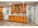 Kitchen area with glass front cabinetry, tile backsplash and wood-look flooring at 21 Lake Ave, Winter Haven, FL 33880