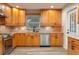Classic kitchen with light wood cabinets, stainless steel appliances, and granite countertops at 21 Lake Ave, Winter Haven, FL 33880