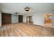 Spacious living room showcasing vinyl plank flooring, wood accent walls and a view of the kitchen at 21 Lake Ave, Winter Haven, FL 33880