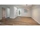 Bright living room boasts wood-look floors, new paint, and a modern light fixture over the dining area at 21 Lake Ave, Winter Haven, FL 33880