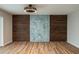 A modern living room features hardwood floors, custom wood paneling, and a unique light fixture at 21 Lake Ave, Winter Haven, FL 33880