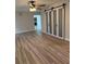 Bright room showcasing barn doors, laminate flooring, and a view into another room at 21 Lake Ave, Winter Haven, FL 33880