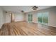 Open-concept living room with LVP floors, modern light fixtures, and sliding glass doors overlooking the water at 21 Lake Ave, Winter Haven, FL 33880