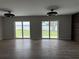 Bright living room featuring wood floors and sliding glass doors with lake views at 21 Lake Ave, Winter Haven, FL 33880