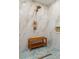 Stylish shower with marble-look tiling, blue mosaic floor, and built-in bench seat at 21 Lake Ave, Winter Haven, FL 33880